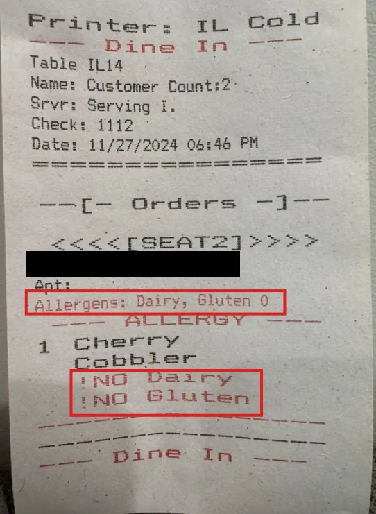 Printed ticket for the cold station listing the customer's allergens, dairy and gluten, with 'No dairy' and 'No gluten' printed under the dessert.